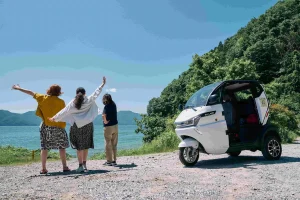 Guests enjoying a scenic stop by Lake Biwa during an electric tuk-tuk tour in Nagahama, Shiga