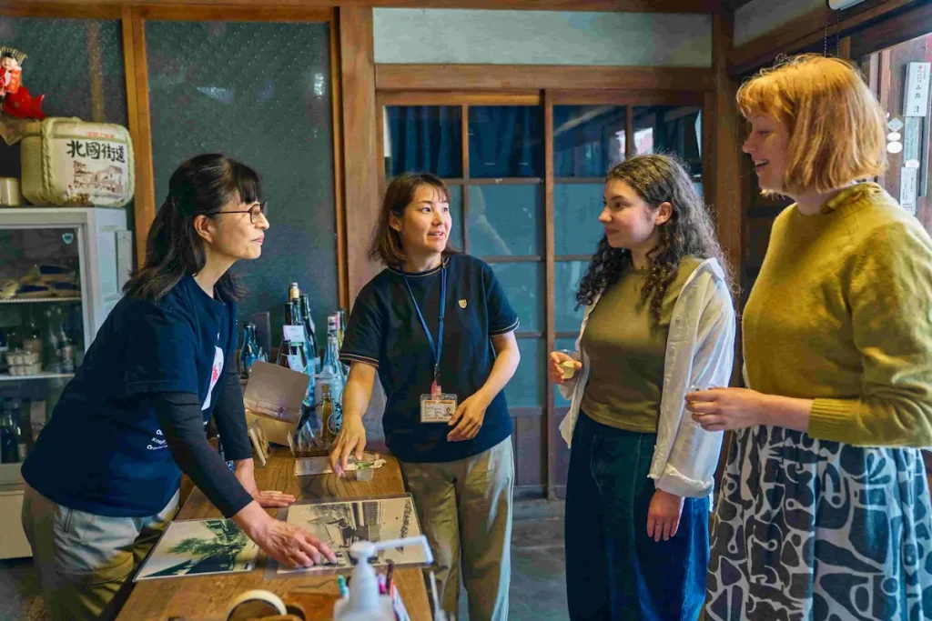 Chatting with a local guide during a sake tasting experience in Kinomoto, Nagahama