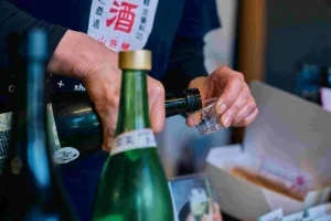 Japanese sake being poured during a tasting at Yamaji Brewery in Kinomoto, Nagahama