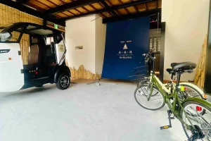 Garage of Guesthouse Ko-Rai-Gen with rental bicycles and an electric tuk-tuk for local travel