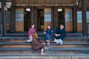 Guests relaxing and chatting with a temple monk after a cultural experience in Nagahama