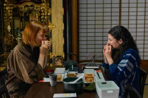 Guests enjoying handmade onigiri rice balls during a traditional Japanese breakfast experience